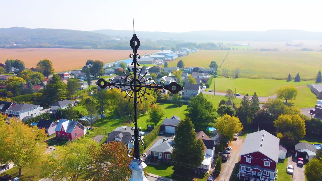Orbital drone shot of a neighborhood and nearby farmlands located in Montr&eacute;al, in Qu&eacute;bec, Canada during fall season
