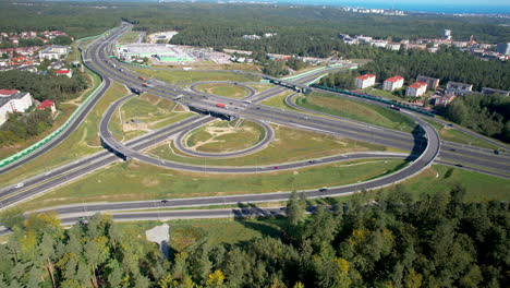 aerial top down shot of traffic on highway with intersection and road junction at sunny day