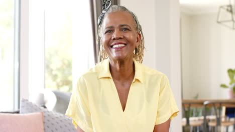 african american senior woman standing in bright room, smiling