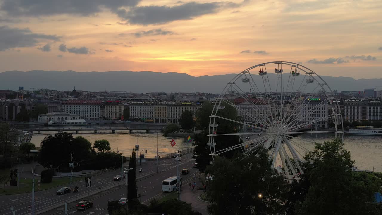 sunset sky geneva city center traffic bridge ferris wheel aerial panorama 4k switzerland