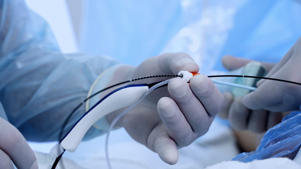 Gloved hands of surgeons holding the tools. Close up. Doctors applying the special device for vascular surgeries.