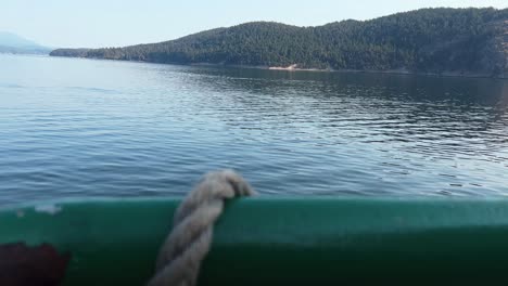 forested mountain scenery viewed from a ferry sailing across orcas island from anacortes in washington, usa