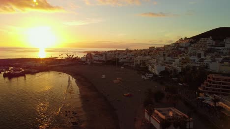 beautiful golden sunset over ocean in village los cristianos, tenerife