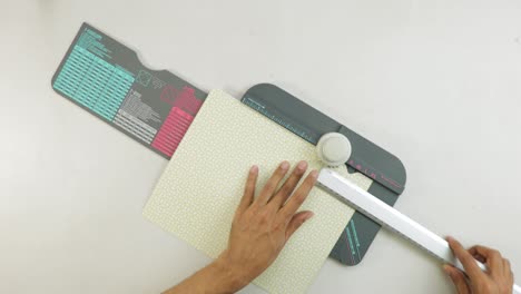 making crafts using patterned paper with ruler and punch board tool