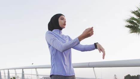 woman wearing hijab stretching outside