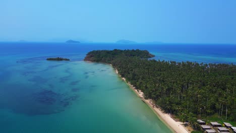 palm trees bordering ao soun yai beach in koh mak, thailand, with turquoise water. unique aerial view flight panorama overview drone