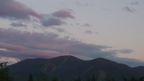 sunset timelapse of ski mountain in new england with clouds moving