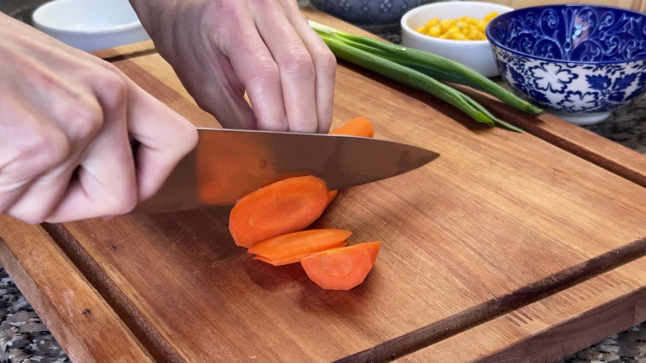 Cutting Fresh Carrots Into Thin Even Circles. Close-up Shot