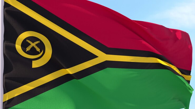 Bandiera di Vanuatu che sventola al vento contro un cielo blu