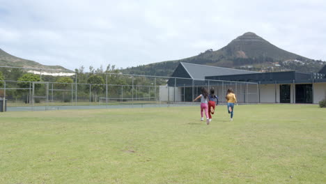 running on school field, two girls enjoying outdoor activity together, copy space