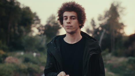 man smoking a cigarette in a park
