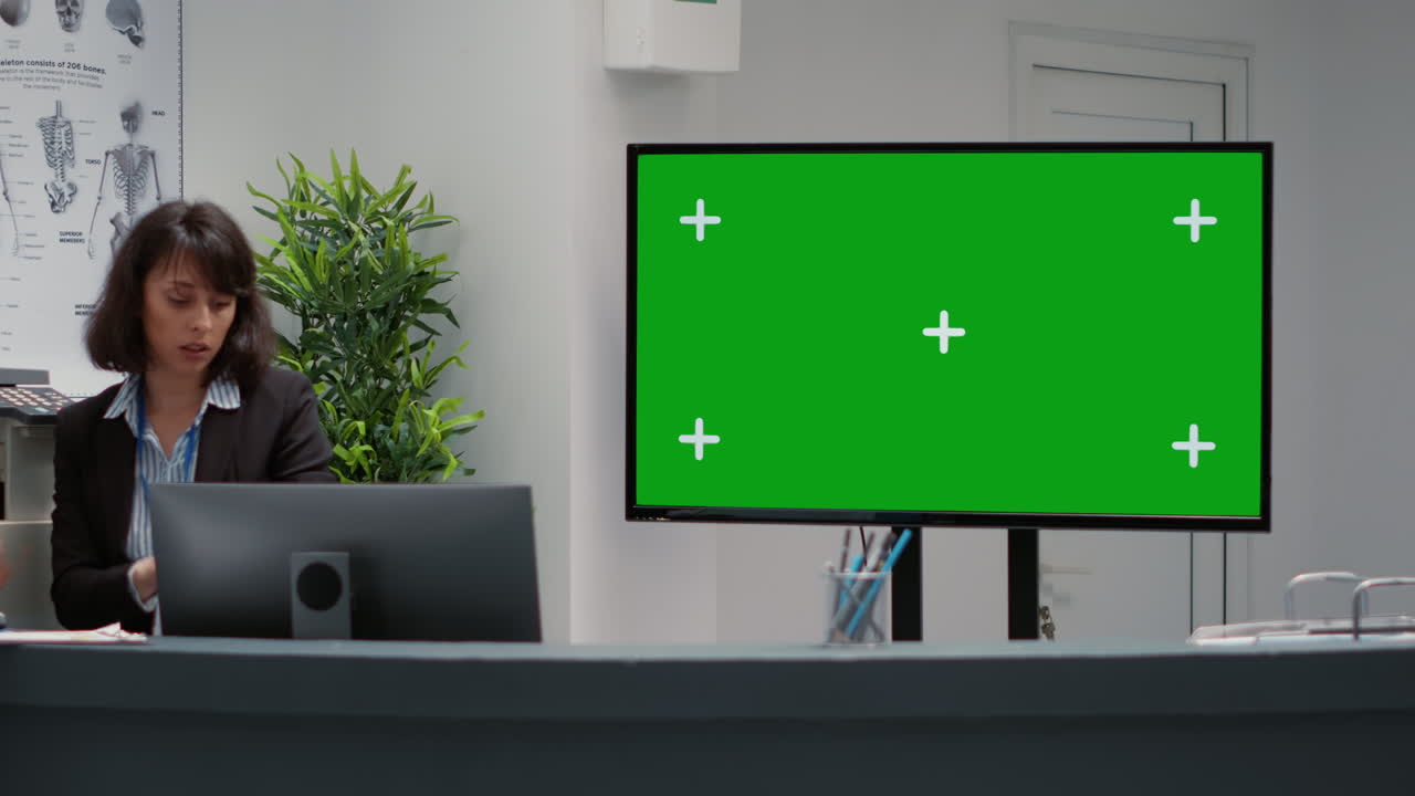 Hospital reception area with green screen monitor