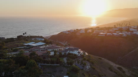 golden lens flare ocean sunset aerial at malibu beach in california