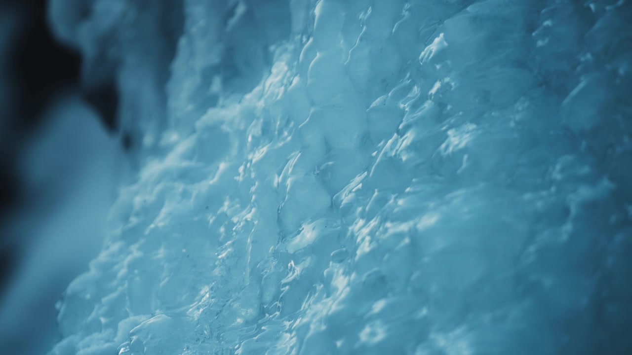 Water flowing down the frozen waterfall
