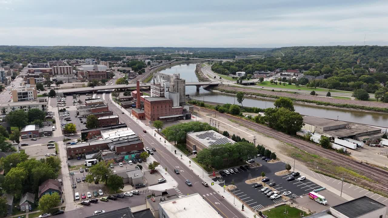 Aerial View of Historic Downtown in Mankato Minnesota, old buildings, grail silos, houses, trees, Minnesota river, overcast skies, North Riverfront Drive