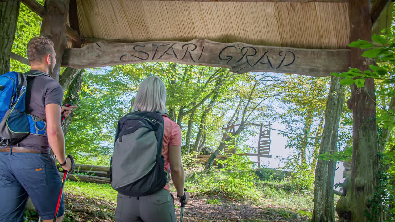 two hikers couple reach Stari Grad , know as old town settlement. Slow motion