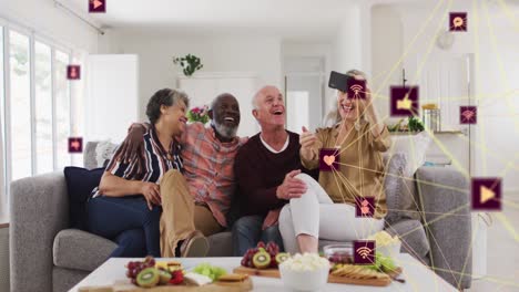 Animation-of-media-icons-over-diverse-group-of-seniors-using-smartphone