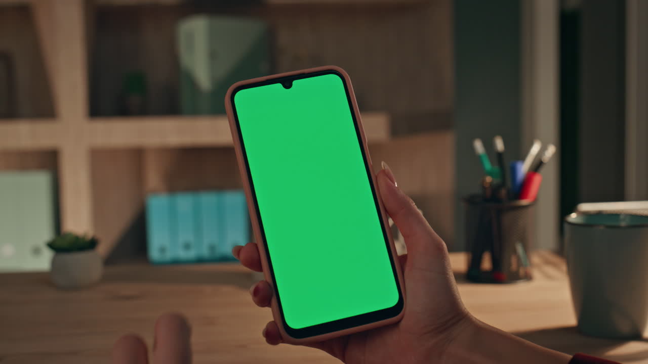 Manager browsing app chroma key smartphone sitting evening office close up.