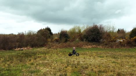 boy riding a bike in the green field 4k