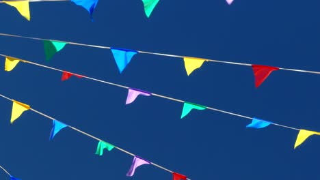 multicolored flags on the blue sky.