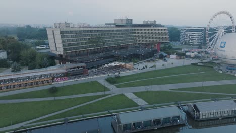 Aerial-Drone-Shot-Krakow-Poland-Abandoned-Soviet-Brutalist-Structure-Hala-Forum-at-Sunrise