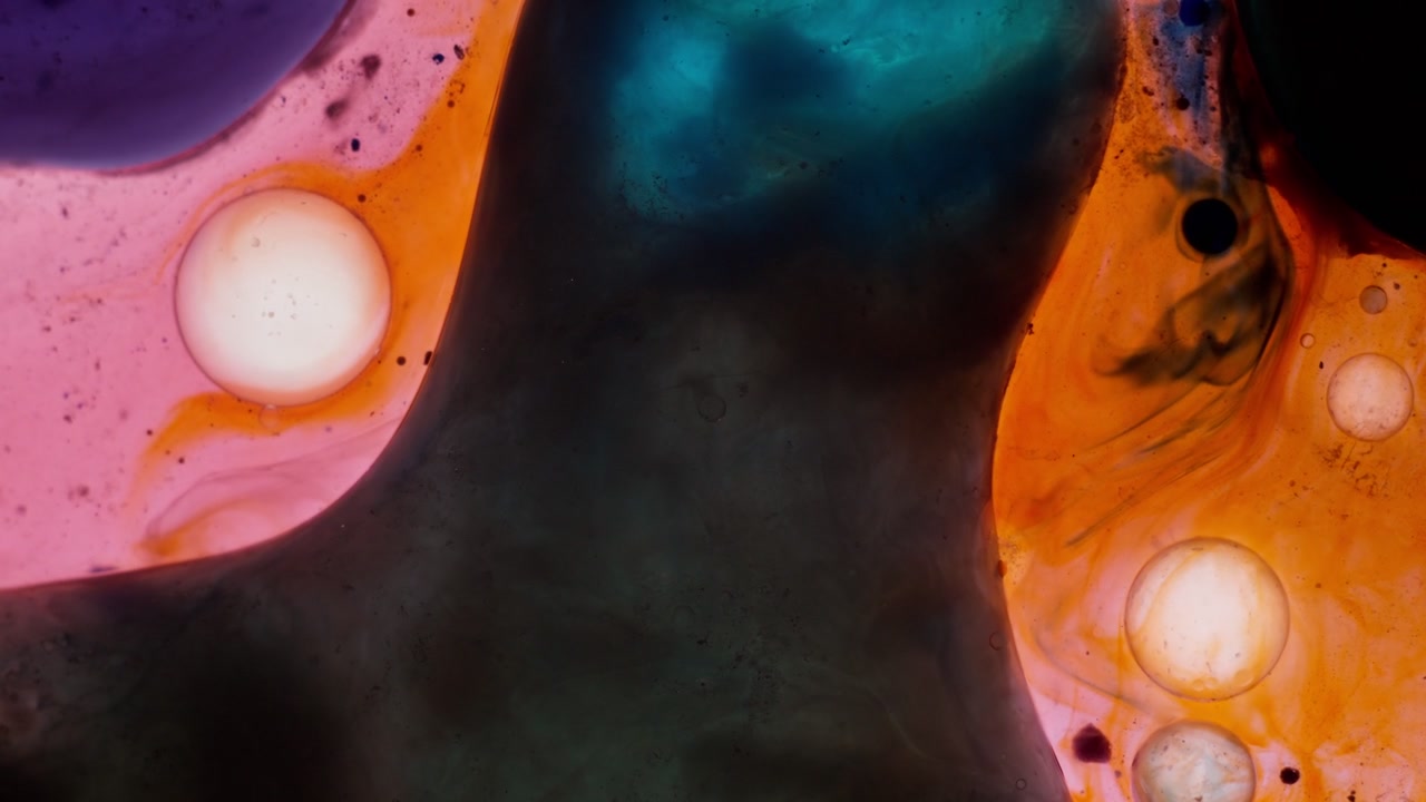 Close-up of orange-hued liquids and teal blobs forming unique organic patterns. Relaxing and tranquil fluid movement for background art and scientific visuals.