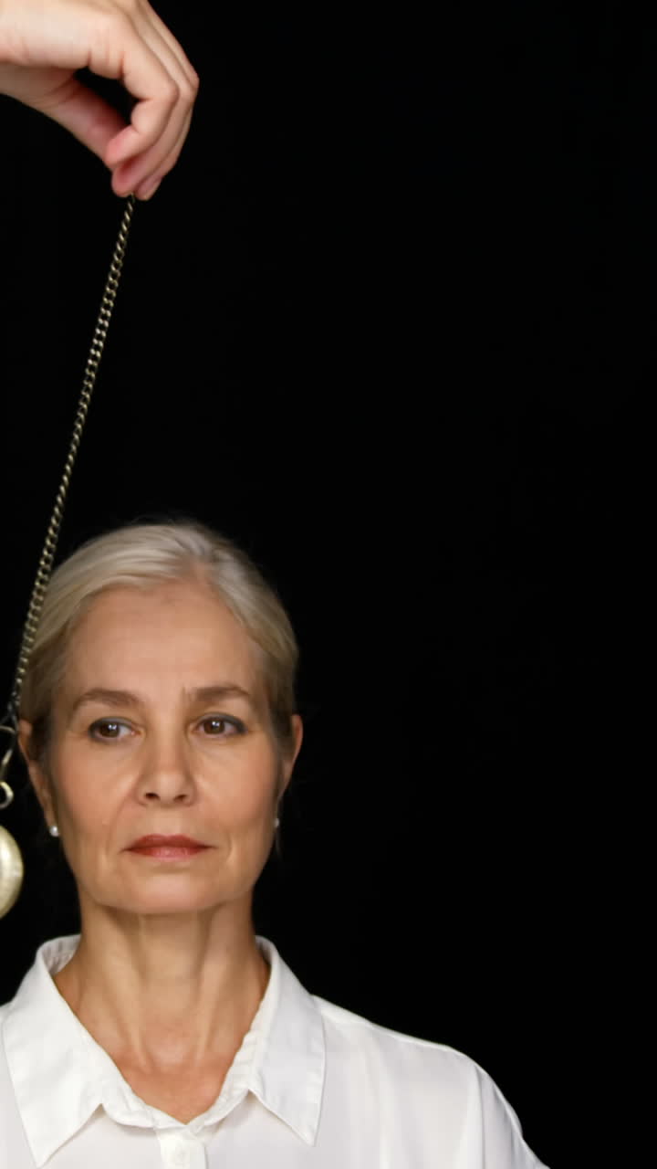 Woman mesmerised by a pendulum movement