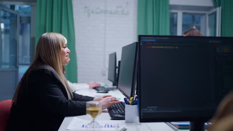 A woman working on a computer in an office