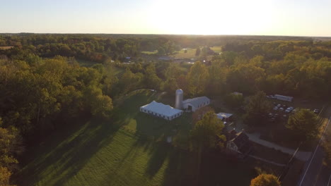 drone shot of outdoor wedding venue in a rural location with fall colors, cinematic aerial shot