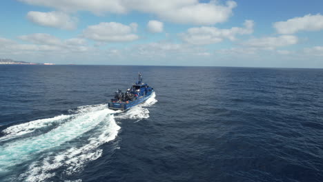 fantastic aerial shot of a customs police patrol car at high speed and on a sunny day