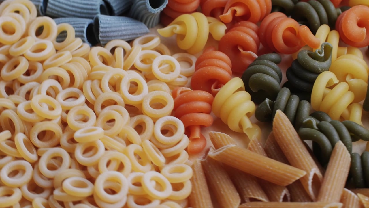 Close-up Panning Shot of Various Uncooked Pasta Shapes