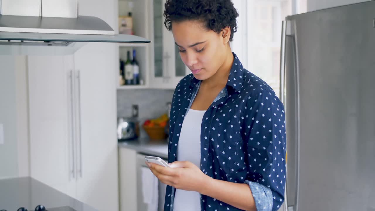 Happy woman using mobile phone while having breakfast 4k