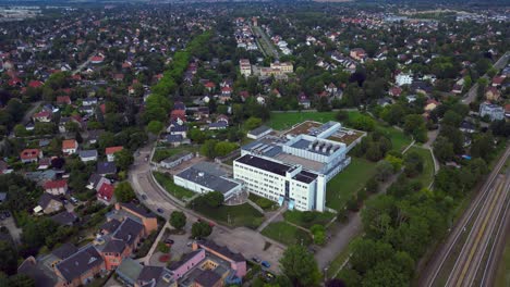 datacenter building with cooling system on the roof, surrounded by residential houses, showcasing urban and industrial integration. lovely aerial view flight wide orbit overview drone