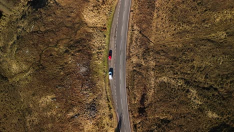 spin rise of mountain road with traffic next to loch loyne in scottish highlands