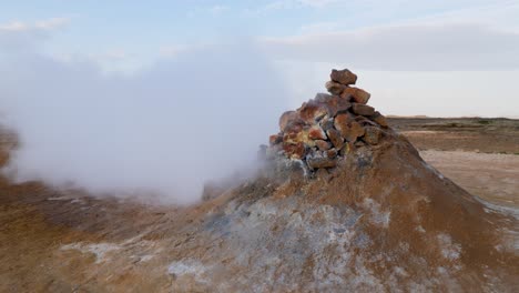 white steam from a sulfuric smoker in iceland blown away by the wind