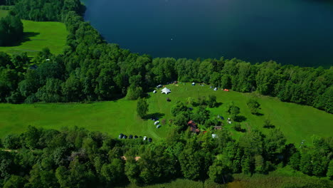 aerial view of homes surrounded by verdant woods and expansive lake