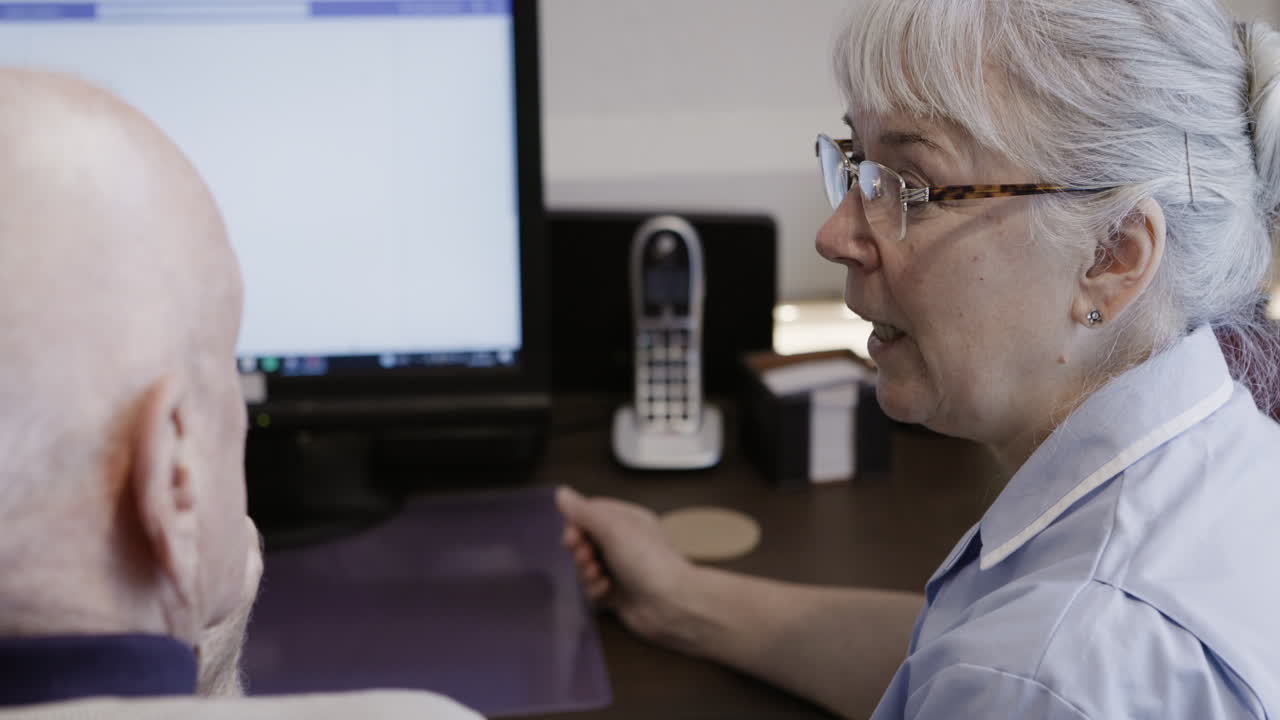 Nurse consulting with patient at computer