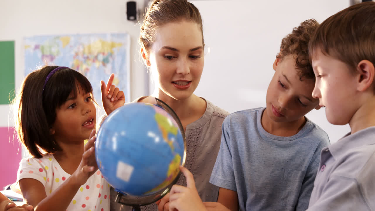 alumnos y profesores en el aula con el globo