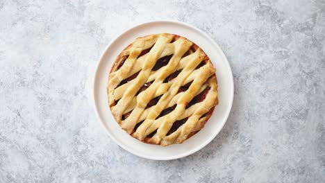 Freshly-baked-homemade-plum-cake-tart-served-on-white-ceramic-nordic-plate