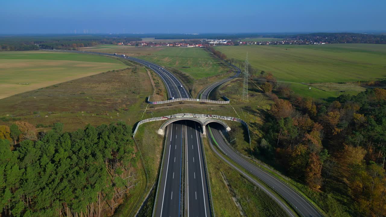 Wildlife crossings Ecoduct, ecopassage, nature ecopassage or green bridge, game changeover. highway in Germany Infrastructure for animals. Smooth aerial view flight panorama overview hovering drone
