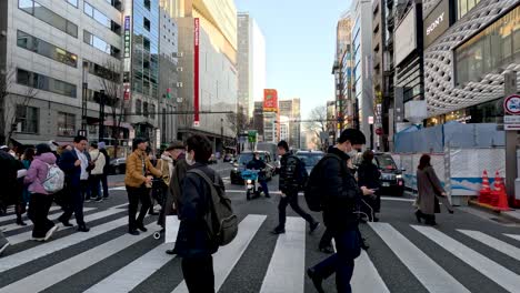 pedestrians crossing busy urban intersection