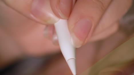 macro close up of a digital pen being used on a tablet to paint