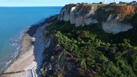 Tilt-up-Reveal-Of-Lighthouse-And-Historical-Landmark-Phare-de-la-Heve-On-High-Limestone-Plateau-Of-Cap-de-la-Heve,-France