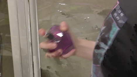 woman applying perfume in bathroom