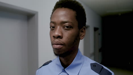 Man-in-uniform-posing-on-the-corridor