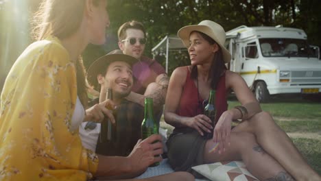 Group-of-young-friends-spending-time-on-the-camper-side.