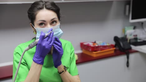 a dedicated dental professional prepares for treatment while wearing protective gear in a clinical setting