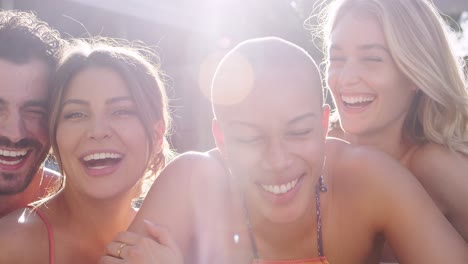 Portrait-Of-Group-Of-Friends-Outdoors-Relaxing-In-Swimming-Pool-And-Enjoying-Summer-Pool-Party