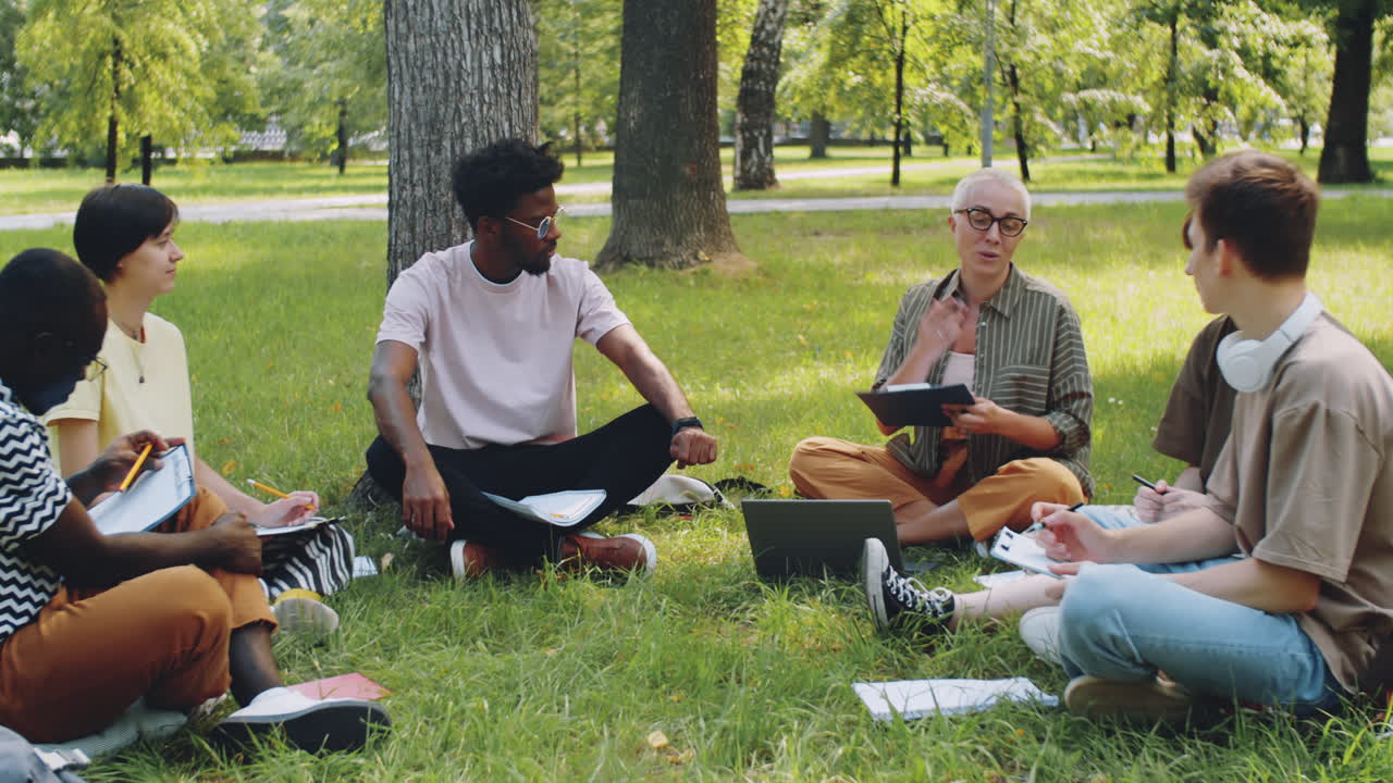 Multiethnic Students and Female Teacher at Outdoor Lesson in Park