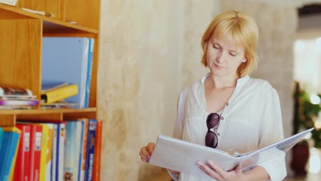 Tourist-Reads-An-Information-Booklet-Stand-Near-The-Hotel